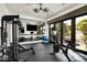 Home gym with workout equipment, mirrors, and sliding doors to an outdoor space at 5858 E Caballo Dr, Paradise Valley, AZ 85253