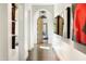 Bright hallway features archways, wood floors, and modern art leading to the bedroom at 5858 E Caballo Dr, Paradise Valley, AZ 85253