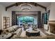 A bright living room flows to the outdoor area featuring a fireplace and comfortable seating at 5858 E Caballo Dr, Paradise Valley, AZ 85253