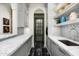 A butler's pantry features gray cabinetry and a black tiled floor at 5858 E Caballo Dr, Paradise Valley, AZ 85253