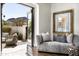 Sitting room featuring a gray sofa, stylish decor, and an open door to the private courtyard at 5858 E Caballo Dr, Paradise Valley, AZ 85253