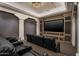 Comfortable theater room featuring tiered seating, a large screen, and custom wood trim for an immersive viewing experience at 5858 E Caballo Dr, Paradise Valley, AZ 85253