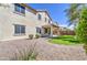 Well-maintained backyard with a covered patio, low-maintenance landscaping, and green grass at 6192 S Claiborne Ave, Gilbert, AZ 85298