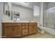 Bathroom with double sink vanity, tile flooring, and a shower at 6192 S Claiborne Ave, Gilbert, AZ 85298