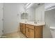 Bathroom with a double vanity, warm lighting and tile floors at 6192 S Claiborne Ave, Gilbert, AZ 85298