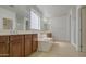 Bright bathroom features a soaking tub, dual sinks, tile flooring, and lots of natural light at 6192 S Claiborne Ave, Gilbert, AZ 85298