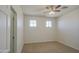 A bright bedroom featuring carpet flooring, neutral walls, and two windows at 6192 S Claiborne Ave, Gilbert, AZ 85298