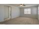 Open bedroom with neutral carpet, a ceiling fan, and an arched doorway to another room at 6192 S Claiborne Ave, Gilbert, AZ 85298