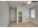 Bright bedroom features a ceiling fan, closet, and natural light from the window at 6192 S Claiborne Ave, Gilbert, AZ 85298