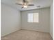 A bright bedroom featuring carpet flooring, neutral walls, and a ceiling fan at 6192 S Claiborne Ave, Gilbert, AZ 85298