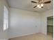 A bright bedroom featuring carpet flooring, neutral walls, and a ceiling fan at 6192 S Claiborne Ave, Gilbert, AZ 85298