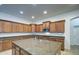 A kitchen showcasing extensive cabinetry, granite countertops, and a large island with a sink at 6192 S Claiborne Ave, Gilbert, AZ 85298