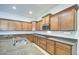 Detailed view of a kitchen island, featuring granite countertops, a stainless steel sink, and wooden cabinets at 6192 S Claiborne Ave, Gilbert, AZ 85298