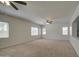 Large living room with multiple windows and modern ceiling fans for comfort at 6192 S Claiborne Ave, Gilbert, AZ 85298