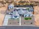 Stunning aerial view of a white single-Gathering home with solar panels, swimming pool, and a spacious, desert-landscaped lot at 6645 N Paint Ln, Casa Grande, AZ 85194