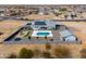 Expansive aerial view showcasing the home's layout, pool, playground, and surrounding desert landscape at 6645 N Paint Ln, Casa Grande, AZ 85194