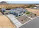 Aerial view of modern single-story home featuring clean lines, solar panels and desert landscape at 6645 N Paint Ln, Casa Grande, AZ 85194