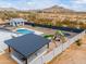 Aerial shot of backyard with pool, playground, and BBQ area against a desert backdrop at 6645 N Paint Ln, Casa Grande, AZ 85194