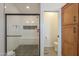 Modern shower featuring black river rock floor and bench, with an adjacent water closet at 6645 N Paint Ln, Casa Grande, AZ 85194