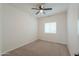 Bedroom with neutral walls, carpet flooring, window with blinds, and a ceiling fan at 6645 N Paint Ln, Casa Grande, AZ 85194