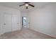 Bedroom with carpet flooring, ceiling fan, closet, and an adjoining room at 6645 N Paint Ln, Casa Grande, AZ 85194