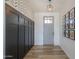 Stylish entryway with decorative wall paneling, modern light fixture and wood-look tile flooring at 6645 N Paint Ln, Casa Grande, AZ 85194