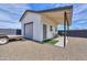 Exterior view of the home showcasing a garage and back patio with gravel landscaping at 6645 N Paint Ln, Casa Grande, AZ 85194