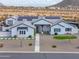 Elegant single-story home with pristine white exterior, solar panels and landscaped front yard at 6645 N Paint Ln, Casa Grande, AZ 85194