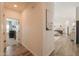 Inviting hallway with wood tile flooring, leads to an open-concept living space and bedroom at 6645 N Paint Ln, Casa Grande, AZ 85194