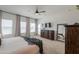 Bright main bedroom with large windows, with neutral carpet and ceiling fan at 6645 N Paint Ln, Casa Grande, AZ 85194