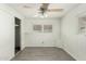 This bedroom is bright with a ceiling fan, wood-look flooring, a closet, and natural light at 730 S Country Club Dr # 5, Mesa, AZ 85210