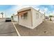 Cozy mobile home featuring gravel landscaping, awning, and neutral color scheme at 730 S Country Club Dr # 5, Mesa, AZ 85210