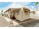 Inviting mobile home with a covered porch, offering outdoor living space at 730 S Country Club Dr # 5, Mesa, AZ 85210