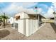 Mobile home showcasing storage unit, air conditioning unit and low maintenance landscaping at 730 S Country Club Dr # 5, Mesa, AZ 85210