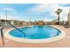 A community pool featuring a round design, clear blue water, and palm trees at 730 S Country Club Dr # 5, Mesa, AZ 85210