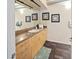 A minimalist bathroom featuring a granite vanity, three framed pictures, and tiled floors at 7301 E 3Rd Ave # 101, Scottsdale, AZ 85251