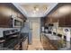 Kitchen featuring dark wood cabinets, stainless steel appliances, and granite countertops at 7350 N Via Paseo Del Sur -- # N104, Scottsdale, AZ 85258