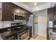 Kitchen featuring dark wood cabinets, stainless steel appliances, and granite countertops at 7350 N Via Paseo Del Sur -- # N104, Scottsdale, AZ 85258