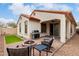 Backyard featuring a patio with seating, a grill, fire pit and lush artificial grass, perfect for relaxation at 7421 W Montgomery Rd, Peoria, AZ 85383