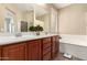 Bathroom featuring double sinks, soaking tub, and large mirror at 7421 W Montgomery Rd, Peoria, AZ 85383