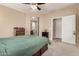 Bedroom with carpet, a ceiling fan, and ensuite bathroom access at 7421 W Montgomery Rd, Peoria, AZ 85383