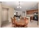 Open dining area adjacent to kitchen features an elegant chandelier and wood table at 7421 W Montgomery Rd, Peoria, AZ 85383