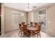 Bright dining room with a wood table set, tile floors, and sliding glass door access at 7421 W Montgomery Rd, Peoria, AZ 85383