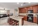 Kitchen with granite counters, center island and barstool seating at 7421 W Montgomery Rd, Peoria, AZ 85383