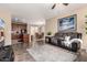 Open-concept living space with hardwood floors, seamlessly connecting the kitchen and dining areas at 7421 W Montgomery Rd, Peoria, AZ 85383