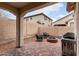 Charming outdoor patio with a fire pit, seating area, and grill, perfect for entertaining at 7421 W Montgomery Rd, Peoria, AZ 85383