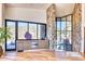 Contemporary bar area with custom cabinetry, stone wall, and windows offering scenic views at 7701 N Silvercrest Way, Paradise Valley, AZ 85253