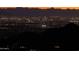 Nighttime view of city lights from a hilltop, showcasing the distant skyline and the residential areas below at 7701 N Silvercrest Way, Paradise Valley, AZ 85253