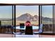 Dining area with floor-to-ceiling windows offering panoramic views of the surrounding landscape at 7701 N Silvercrest Way, Paradise Valley, AZ 85253