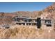 Striking modern home perched on a hillside, featuring multiple levels with balconies and terraces, showcasing contemporary architecture at 7701 N Silvercrest Way, Paradise Valley, AZ 85253